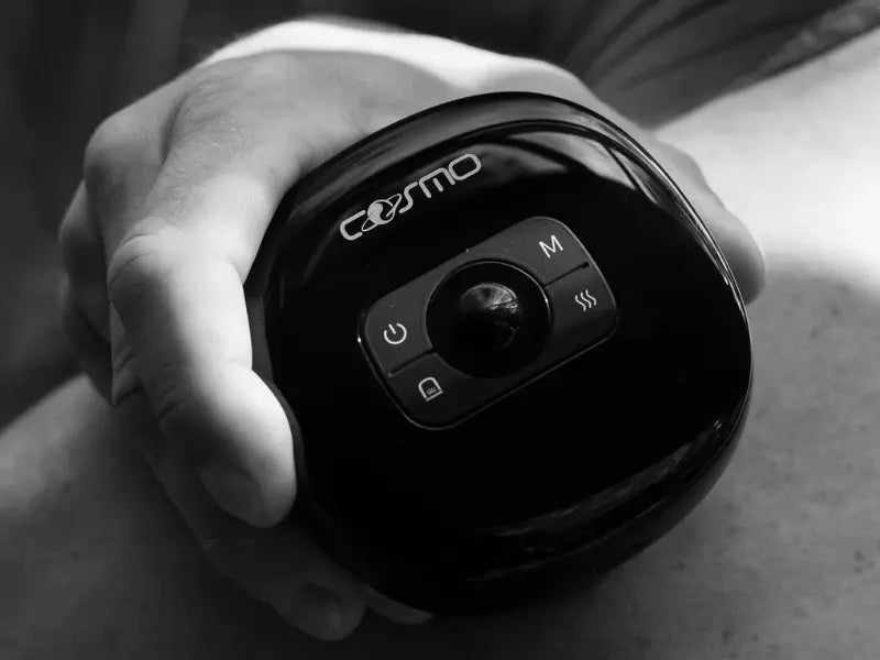 Cupping therapy device held in hand, highlighting control interface and ergonomic design.