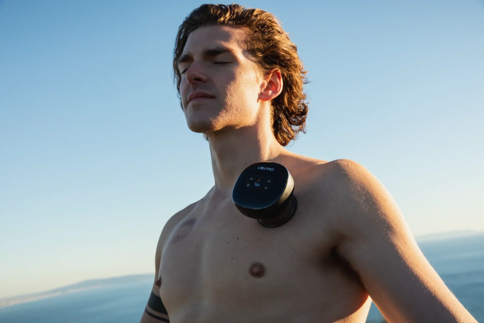 Cupping therapy device placed on upper chest of a man during outdoor relaxation session.