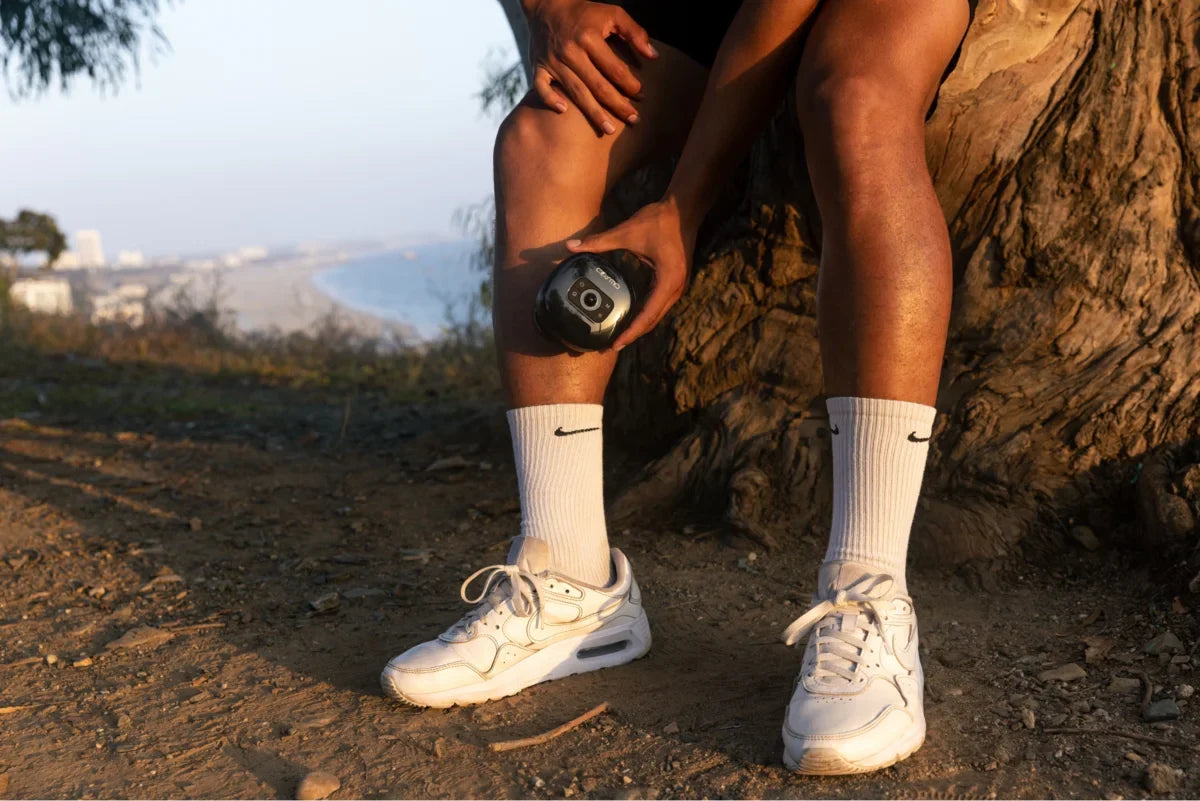 Fascia release tool used on lower leg muscles during outdoor recovery session.