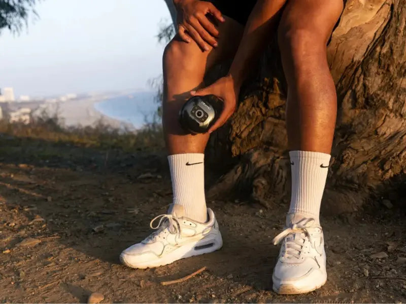 Cupping for muscle recovery shown on lower leg during outdoor relaxation session.