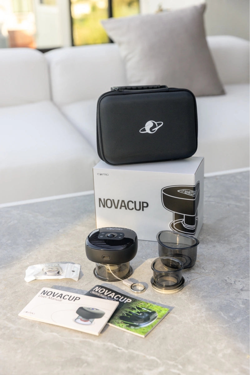 Portable cupping massager set with accessories, user manuals, and carrying case displayed on a table in a modern living room.